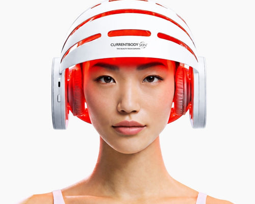 Woman using CurrentBody LED Hair Growth Helmet on her head