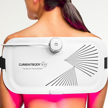 CurrentBody LED Light Therapy Panel on woman's back for pain relief and skin treatment