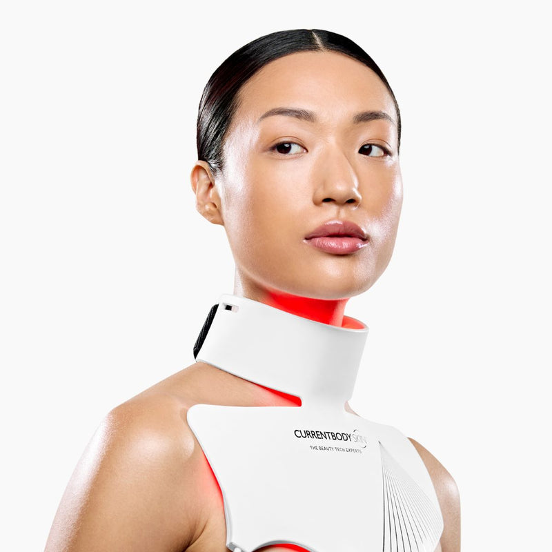 Woman using CurrentBody LED Neck & Décolletage Mask Series 2 on her neck and chest